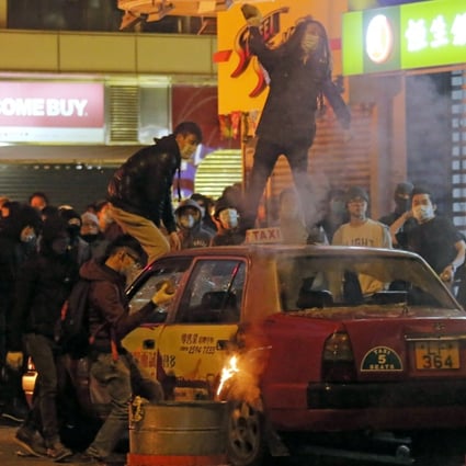 Rioters throw bricks at police in Mong Kok. Photo: AP