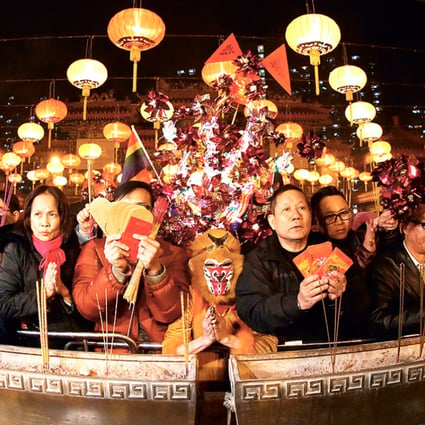 Worshippers including ex-actress Lana Wong Hai-wai (centre) dressed in monkey costume offer the first incense at Wong Tai Sin Temple on Lunar New Year's Eve. 07FEB16 SCMP/Nora Tam