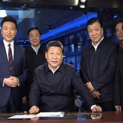 President Xi Jinping sits in the presenter’s chair of Xinwen Lianbo, the 7pm prime-time news programme, surrounded by two hosts and other officials in the CCTV studio. Photo: Simon Song