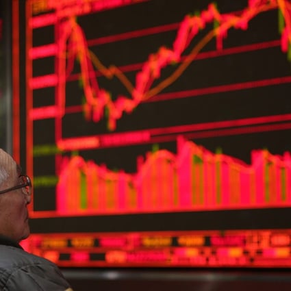 A Chinese investor watches a screen showing share prices at a securities brokerage in Beijing. The decision to replace Xiao Gang follows a failed gamble last month on a circuit breaker that led to extreme market volatility. Photo: EPA