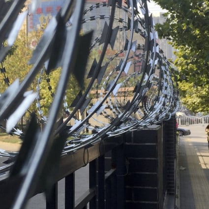 Barbed wire protects a residential compound in Beijing. The Chinese government plans to open all gated communities to the public, causing concerns over security and private property rights. Photo: Simon Song