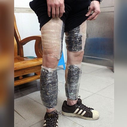 Unsuccessful bid to stay a step ahead of the law. The suspect shows his ‘leggings’ of phone memory cards. Photo: CCTV