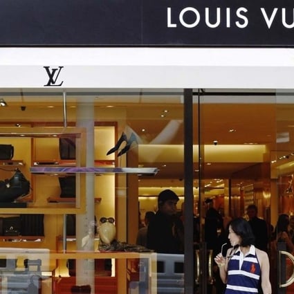 A woman exits a Louis Vuitton shop on New Bond Street, London. The luxury retail market is still very active in London despite broader economic concerns, say property analysts. Photo: Reuters