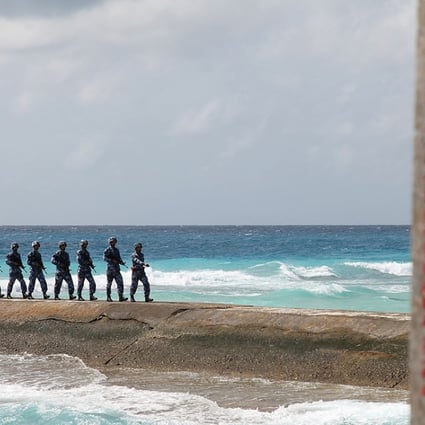 PLA troops stationed on a disputed island in the Spratly chain in the South China Sea. Photo: Reuters
