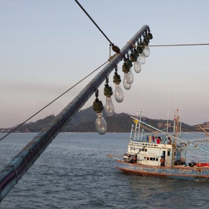 Fishing boats leave for the ocean at dusk. Photo: SCMP Pictures