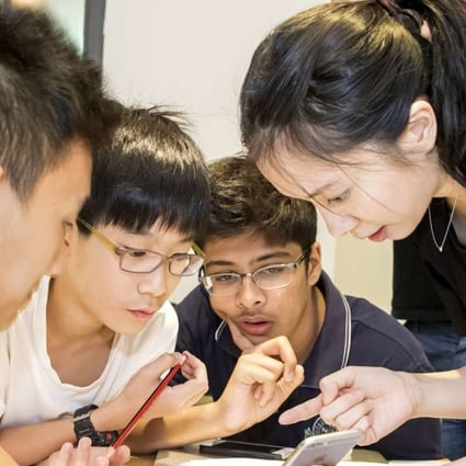 Michelle Sun (Right) Founder and CEO of First Code Academy teach students how to design an app at a programming school in Wan Chai. Photo: SCMP Pictures
