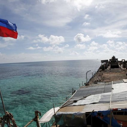 A Philippine flag flutters from BRP Sierra Madre in the Spratly Islands. Photo: Reuters