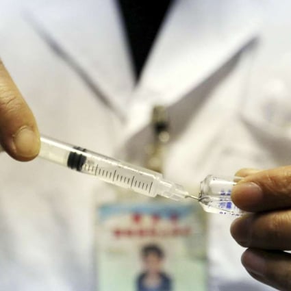A health worker prepares a child's vaccination at a health station in Rongan county in Guangxi. Photo: AP