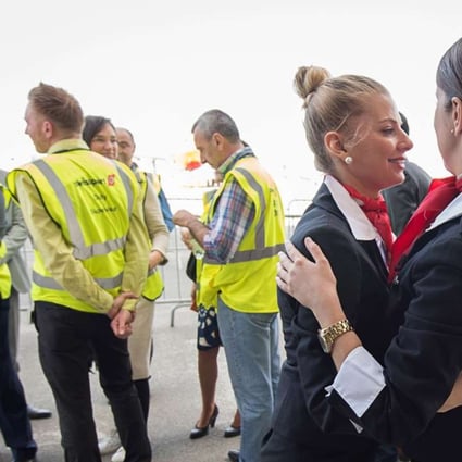 Emotional Brussels airport employees celebrate on Sunday after the first flight since the recent terrorist attacks took off from Brussels’ Zaventem Airport. Photo: AFP