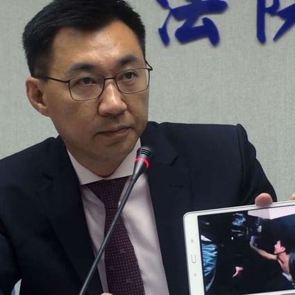 Johnny Chiang, from the Kuomintang party, displays a video clip in Taipei showing Taiwanese detained at a police station in Kenya. Photo: AFP April 12, 2016. Taiwan accused China on April 11 of kidnapping eight Taiwanese who had been cleared of criminal charges by a court in Kenya, and angrily demanded their immediate return from the mainland. / AFP PHOTO / SAM YEH
