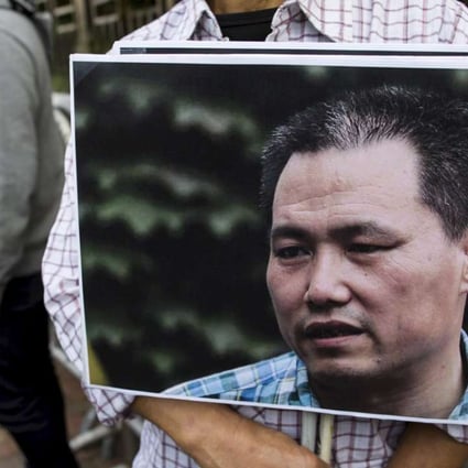 A pro-democracy protester holds a portrait of Chinese human rights lawyer Pu Zhiqiang, in Hong Kong, in December. Photo: Reuters
