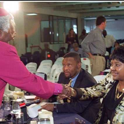 Winnie Madikizela-Mandela flanked by her legal team, shaking hands with Archbishop Desmond Tutu, chairman of the Truth and Reconciliation Commission in 1997. Photo: AFP