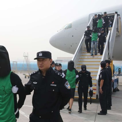 Tlecom fraud suspects deported from Kenya arrive at Beijing Capital International Airport in Beijing. Kenyan police deported 77 suspects, including 45 Taiwanese, to the mainland. Photo: Xinhua