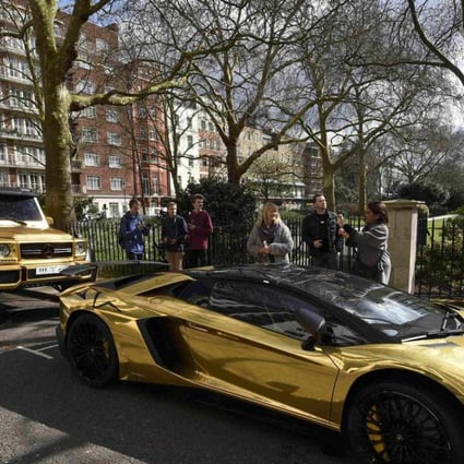 Super cars with a gold wrap finish are seen parked in a street in Knightsbridge in London on March 31, 2016. Photo: Reuters