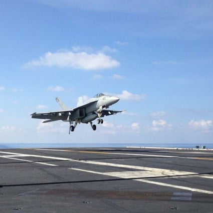 An FA-18 jet fighter takes off on the USS John C. Stennis, an American aircraft carrier in the South China Sea on Friday, April 15, 2016. US ships have started conducting joint patrols in the South China Sea with the Philippines. Photo: AP