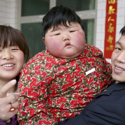 Two-year-old Pang Ya (the Chinese term for fat girl), who weighs 41.5kg, with her parents at home in Yuncheng, Shanxi province. Photos: Corbis