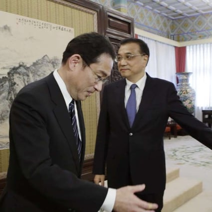 China's Premier Li Keqiang (right) shows the way to Japanese Foreign Minister Fumio Kishida during a meeting at the Zhongnanhai leadership compound in Beijing on Saturday. Photo: AP