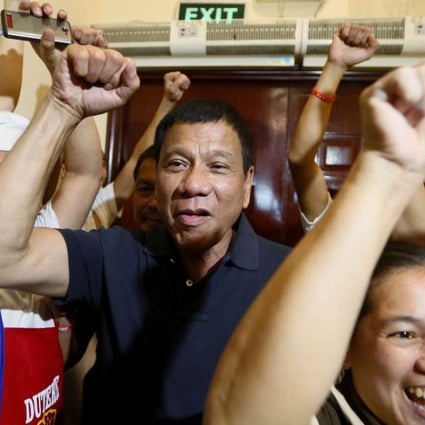Philippine presidential candidate Rodrigo Duterte being cheered by the kitchen staff of a restaurant in Manila. Photo: AP
