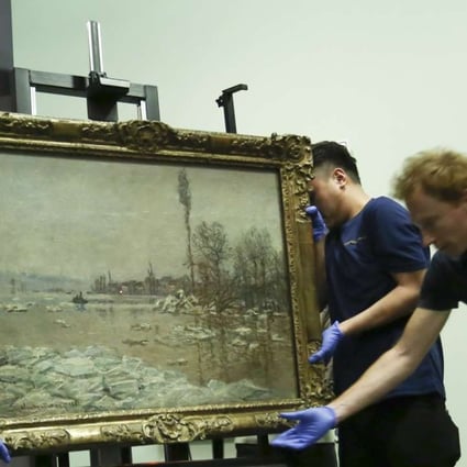 Heritage Museum staff set up the Monet exhibition Claude Monet: The Spirit of Place. Photo: Jonathan Wong