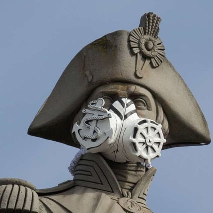 A nautical themed breathing mask is fixed to Lord Nelson's statue at the top of Nelson's Column in Trafalgar Square, central London on April 18, 2016. The stunt was part of a series that were carried out across the capital by Environmental protest group Greenpeace by adding masks to famous statues, to highlight air pollution in the capital. Photo: AFP