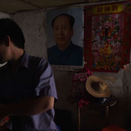 A family home in Wuxuan with a picture of Mao Zedong hanging on the wall. Mao launched the Cultural Revolution, which caused a decade of political turmoil in China. Photo: AFP