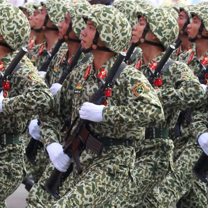 Soldiers hold rifles while marching during a celebration to mark Reunification Day in Ho Chi Minh city, Vietnam April 30, 2015. REUTERS/Kham