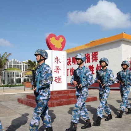 China's People's Liberation Army personnel at Fiery Cross Reef in the Spratly Islands. Photo: Reuters