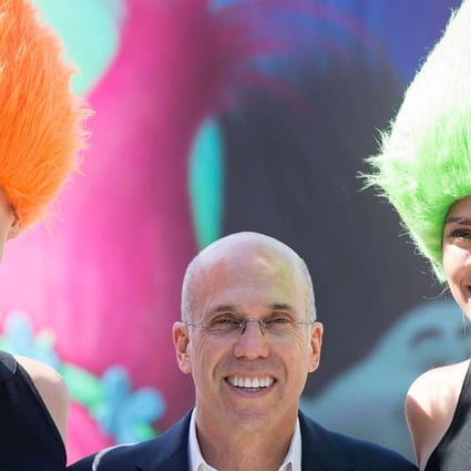 DreamWorks boss Jeffrey Katzenberg poses with two models in Berlin, Germany while promoting Trolls. Photos: EPA