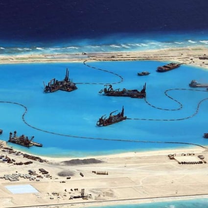 The Pentagon report includes photographs of the contentious islands, including Fiery Cross Reef, above, in the South China Sea. Photo: EPA
