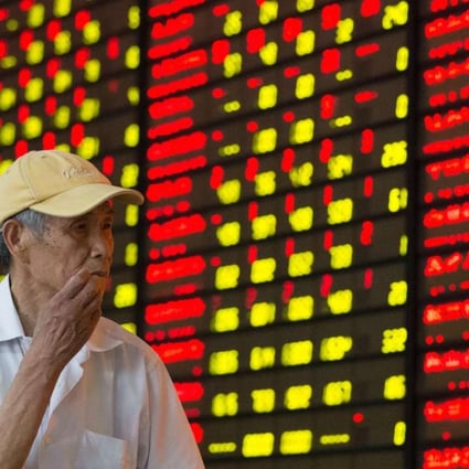 An investor follows stock movements at a trading hall in Nanjing, capital city of east China's Jiangsu province. Photo: Xinhua