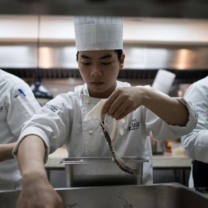 Chefs at work in a French restaurant kitchen in Shanghai. The first Michelin guide to the city’s restaurants will be published this year. Photo: AFP