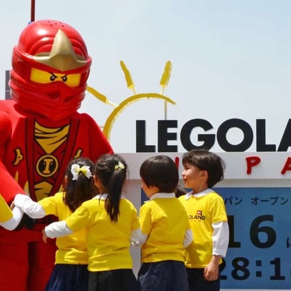 Kindergarten pupils play with a Lego mascot during a ceremony in Nagoya on May 19 to announce the opening of Japan's first outdoor Legoland theme park next year. Photo: Kyodo