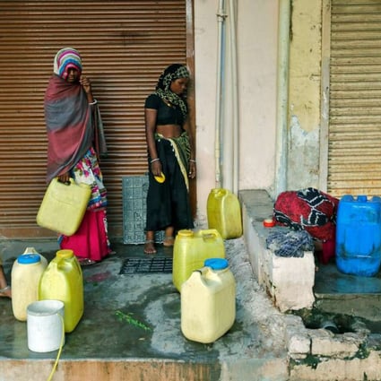 Women fill water containers from an underground tank on the outskirts of Ahmedabad, India. Improved access to sanitation, electricity, clean water supplies and transport reduces “time poverty” for women and girls, according to a study by the Asian Development Bank. Photo: Reuters