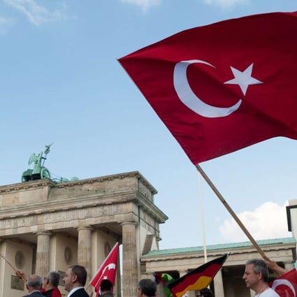 A demonstration march of several Turkish associations passes the Brandenburg Gate in Berlin. Photo: EPA