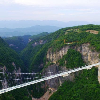 Construction for the world’s longest and highest glass-bottomed bridge above the Zhangjiajie Grand Canyon in central China’s Hunan province is completed. Photo: SCMP Pictures