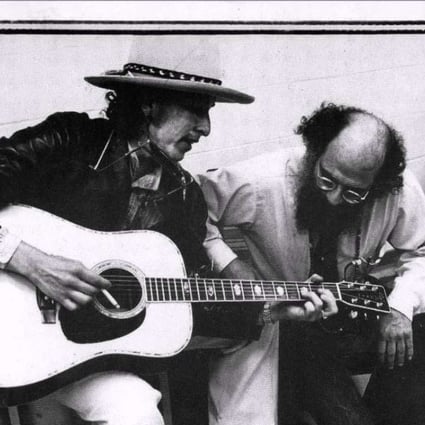 Allen Ginsberg gets a lesson in chord structure from Bob Dylan in this undated photo.