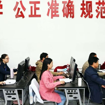 China’s education officers monitor students taking their university entrance exam in Zhengzhou, Henan province, earlier this month. Photo: AFP