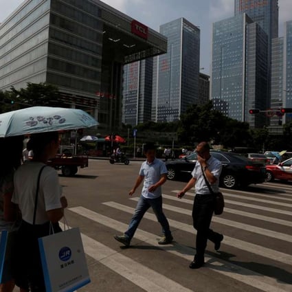People cross a street in Shenzhen’s Nanshan district. Shenzhen is now ranked among those cities in China with the cleanest air. Photo: Reuters