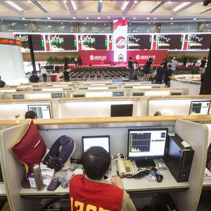A trader sits in front of a computer at the Shanghai Stock Exchange. Officials there are working with their London counterparts to create a trading link between the two exchanges. Photo: Qilai Shen, Bloomberg