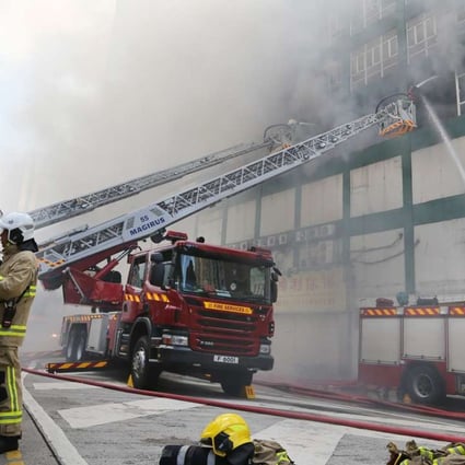 Battling exhaustion, Hong Kong firefighters continue to combat deadly