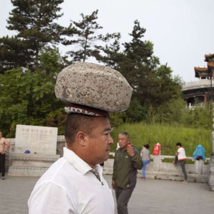 Cong Yan can easily carry the 40kg boulder on his head for a distance of 3,000 metres, mainland media reported. Photo: SCMP Pictures