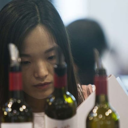 A Chinese buyer of fine wine attends Vinexpo in Hong Kong in May. Photo: EPA