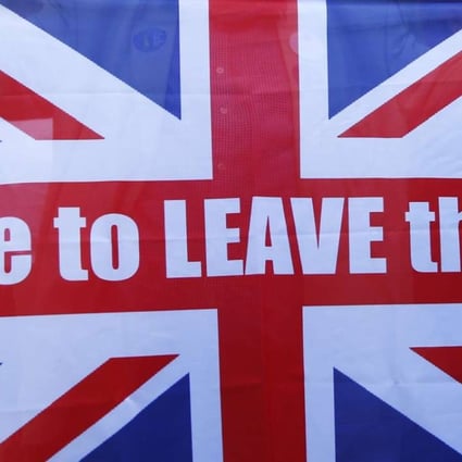 A vote Leave supporter holds up a Union flag outside Downing Street. Photo: Reuters