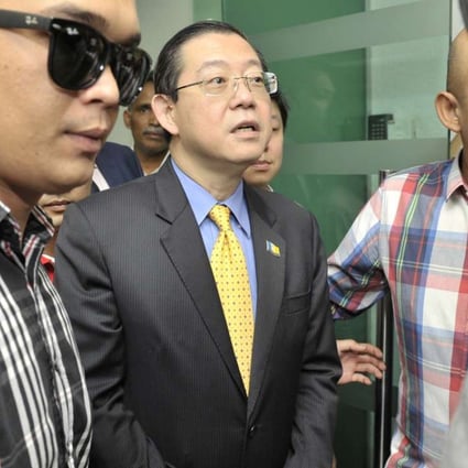 Lim Guan Eng (centre) being taken from his office in Penang by the Malaysian Anti-Corruption Commission. Photo: AP