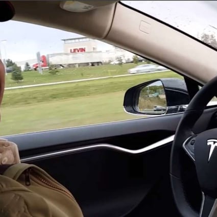 A still image from a YouTube video showing Joshua Brown in the driver's seat of his Tesla Model S with no hands on the steering wheel while he demonstrates the car's self-driving mode. Photo: AP