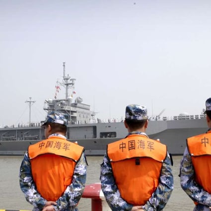 In this May 6 file photo, soldiers from the People's Liberation Army Navy watch as the USS Blue Ridge arrive at a port in Shanghai. Photo: AP