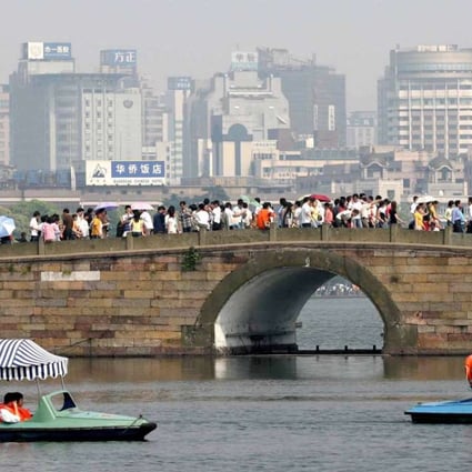 Tourists visit West Lake, a scenic spot in Hangzhou. The city government’s masterplan is to shift development from West Lake to the southbank of the Qiantang River, where four new subway lines are being built. Photo: Xinhua