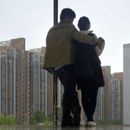 A couple in Beijing. CASS is warning that in China’s larger cities, some are now borrowing as much as nine times their own money to buy a property. Photo: Wang Zhao, AFP