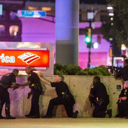 Dallas police take cover after shots were fired at a Black Lives Matter rally in downtown Dallas on Thursday, July 7, 2016. Photo: The Dallas Morning News