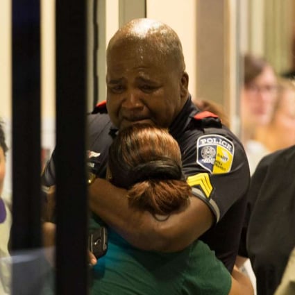 A DART (Dallas Area Rapid Transit) police officer receives comfort at Baylor University Hospital emergency room entrance on Thursday, July 7, 2016, in Dallas. Photo: TNS